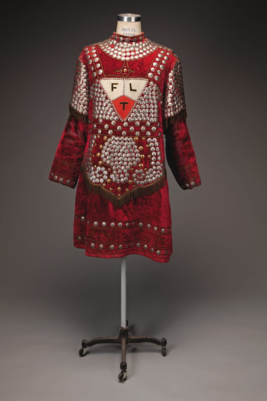 Odd Fellows Master at Arms costume, ca. 1900–1920 C. E. Ward, New London, Ohio Red velvet tunic and leggings with nickel decorative disks, matching shoes and hat Webb Collection