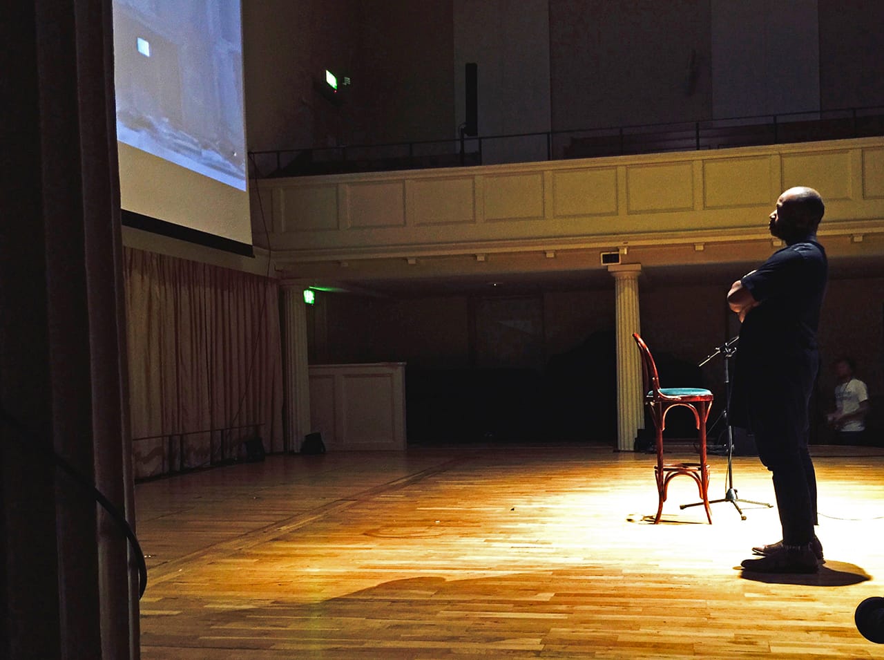 Theaster Gates surveys a video during prep for his Saturday night presentation (all photos by the author for Hyperallergic)
