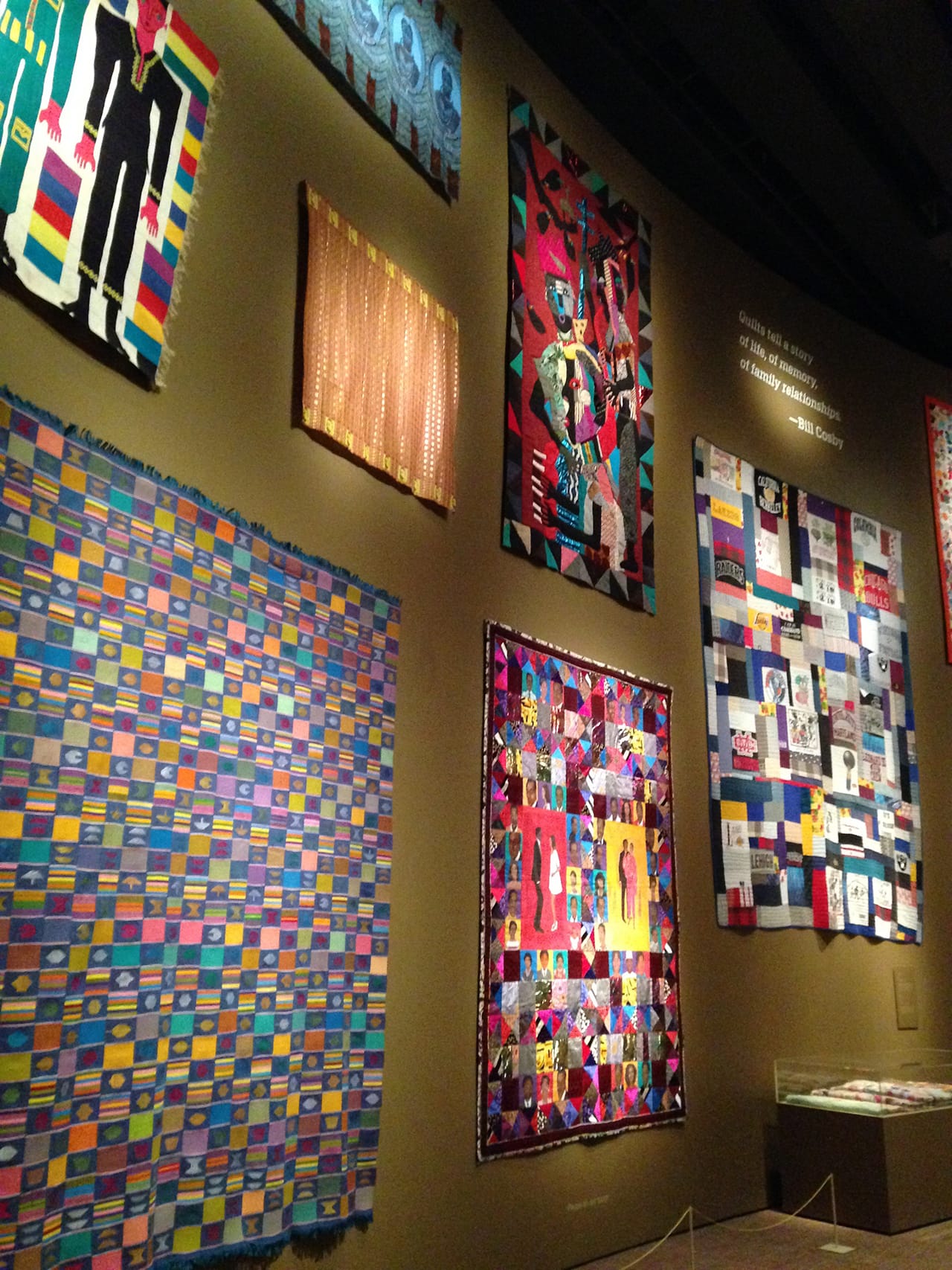 Installation view of the quilt wall in Conversations,' with Faith Ringgold's quilt featuring Bill and Camille Cosby at bottom center and Bill Cosby's quote highlighted at the top