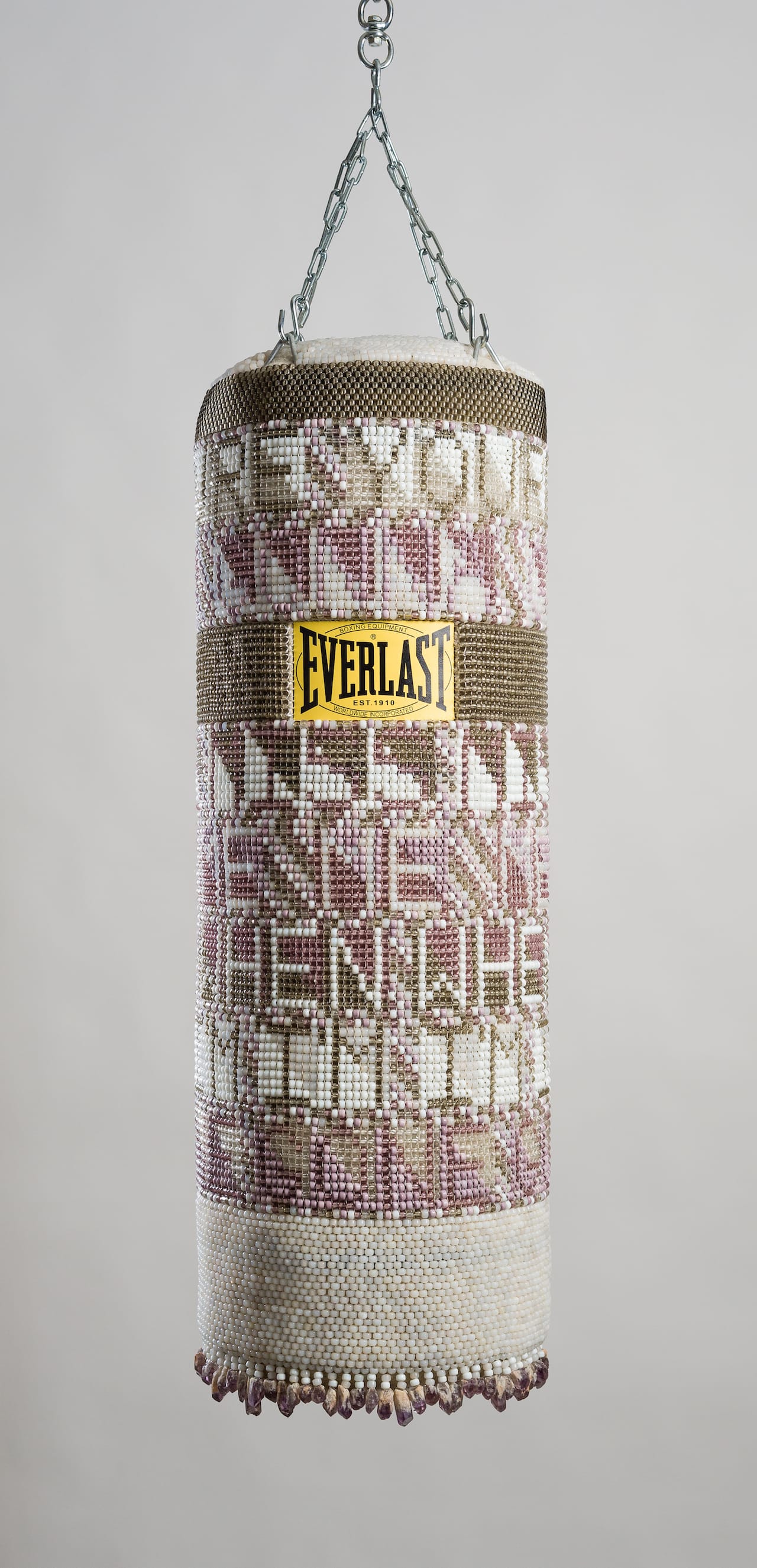 Jeffrey Gibson, "YOU'RE GONNA MISS ME WHEN I'M GONE" (2015), repurposed punching bag, glass beads, artificial sinew, amethyst, steel, 41 x 14 x 14 inches