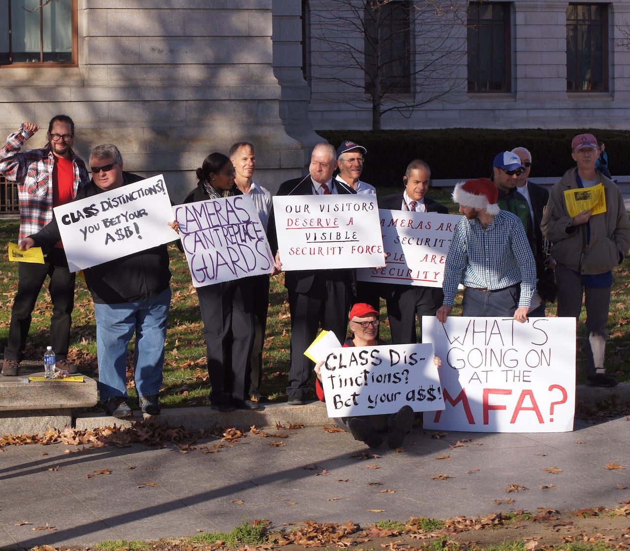 Protestors stood outside the main entrance of the MFA Boston on Huntington Avenue passing out leaflets, chanting, and singing while engaging museum patrons and other passersby.