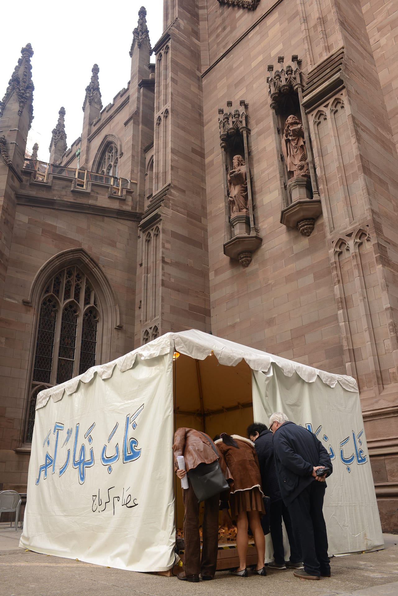 Artist Issam Kourbaj at St. Paul's Chapel and with his installation, Another Day Lost, in Trinity Church's south churchyard.