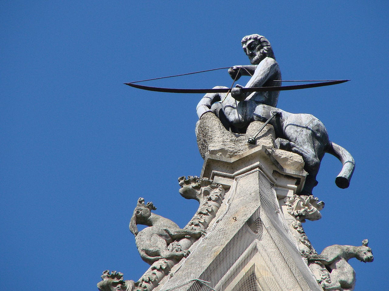 A sculpture of a Sagittarius atop the south transept of the cathedral in Reims (photo by Vassil, via Wikimedia Commons)
