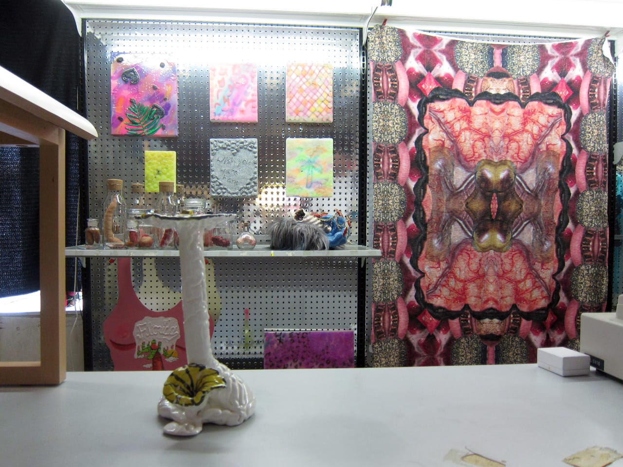 Bong by Andrew Cornell Robinson, towel by Jesse Firestone, bottled sculptures by Ellie Dent, and paintings by Liz Guzman