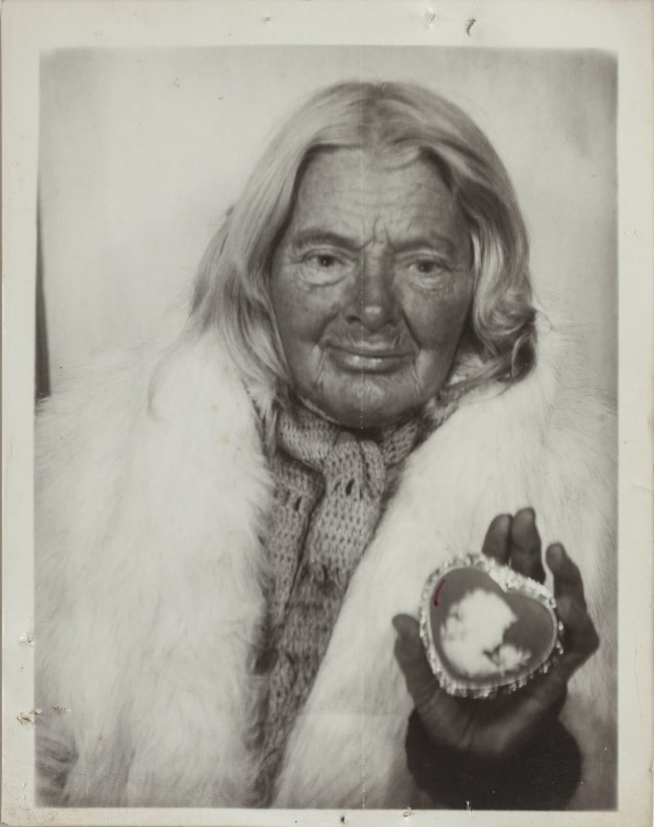Lee Godie, untitled (in white fur stole with heart-shaped cameo), n.d., gelatin silver print, 4¾ x 3¾ in. (click to enlarge)