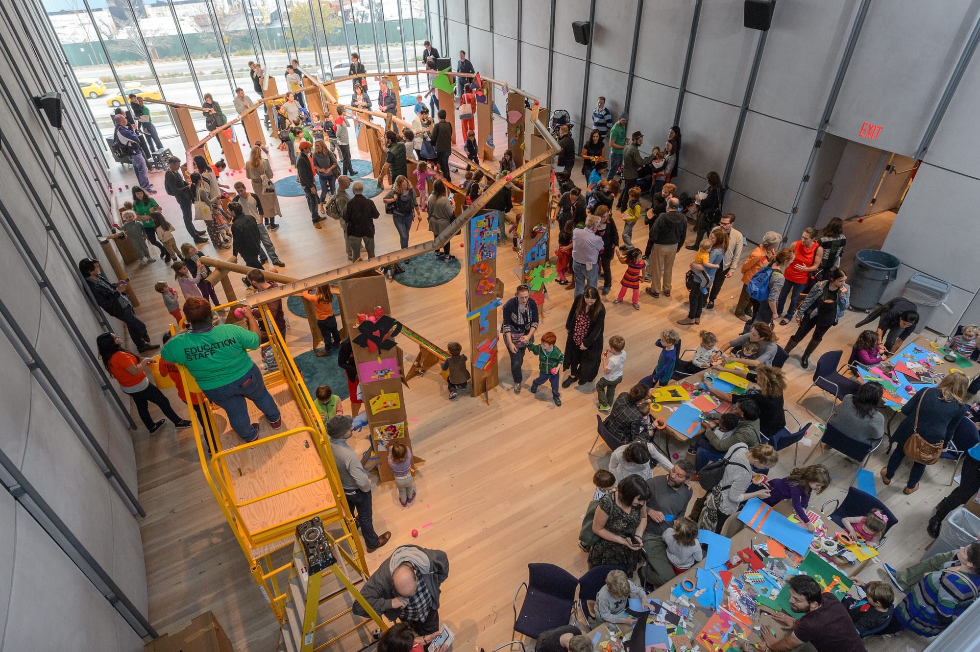 Families activate a giant marble run, designed by artist McKendree Key in the Laurie M. Tisch Education Center, 2015. Photo by Filip Wolak