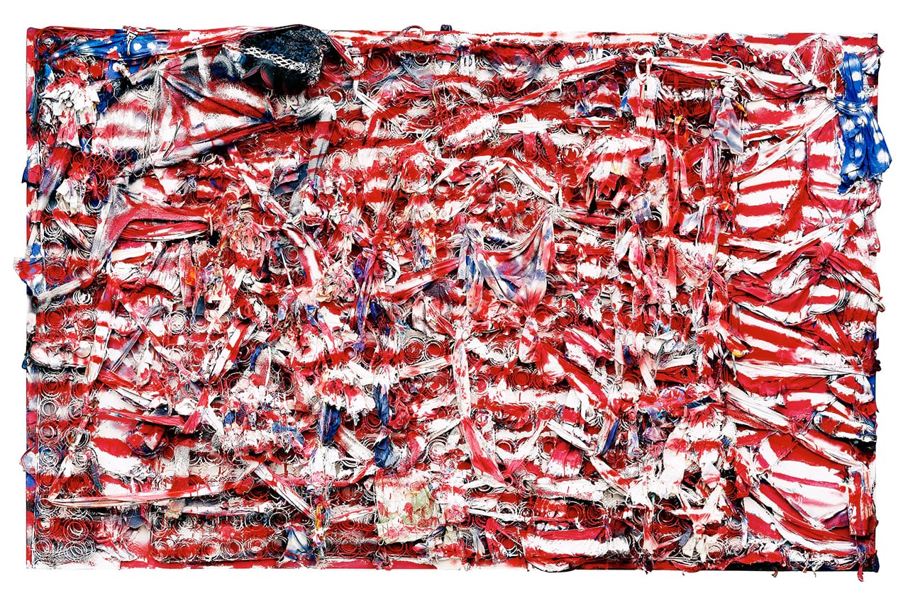 Thornton Dial, “Don’t Matter How Raggly The Flag, It Still Got To Tie Us Together” (2003), mattress coils, chicken wire, clothing, can lids, found metal, plastic twine, wire, Splash Zone compound, enamel, and spray paint on canvas on wood, 71 x 114 x 8 inches, collection of Indianapolis Museum of Art (photo by Stephen Pitkin/Pitkin Studio, courtesy Souls Grown Deep Foundation) (click to enlarge)