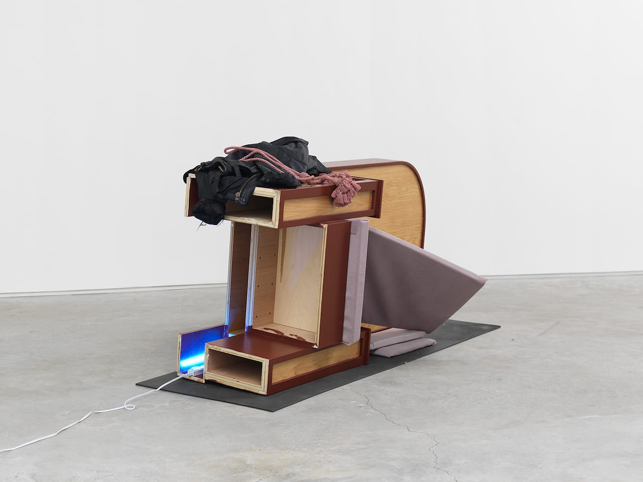 Lizzi Bougatsos, "After the Pope Party" (2016), wood, leather, rope, foam, polyester, yoga mat, and neon light, 32 x 72 x 26.5 in