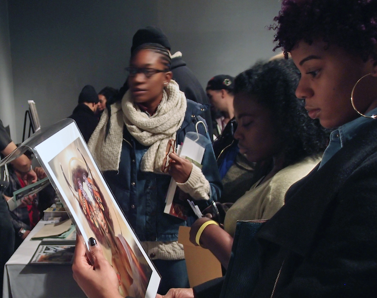 Woman looking at original art for sale