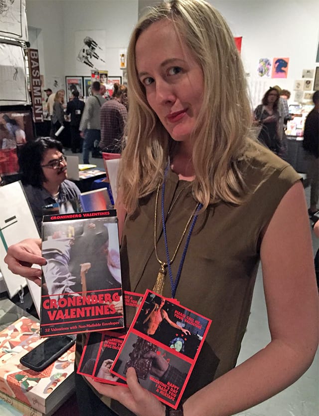 Samantha Culp shows off her David Cronenberg Valentines gift box set at the New Territories booth.