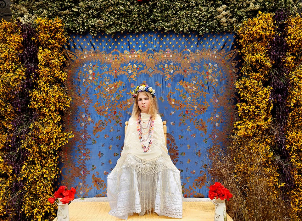 A 'Maya' girl sits in an altar during the traditional celebration of 'Las Mayas' on the streets of the small village of Colmenar Viejo, near Madrid, Spain on Saturday, May 2, 2015. The festivity of 'Las Mayas' comes from pagan rites and dates from at least the medieval age, appearing in ancient documents. It takes place every year in the beginning of May and celebrates the arrival of the spring. A girl between 7 and 11years is chosen as 'Maya' and should sit still, serious, and quiet for a couple of hours in an altar on the street decorated with flowers and plants, afterwards they walk to the church with their family where they attend a ceremony. Not more than four, or five girls are chosen as a Maya each year.