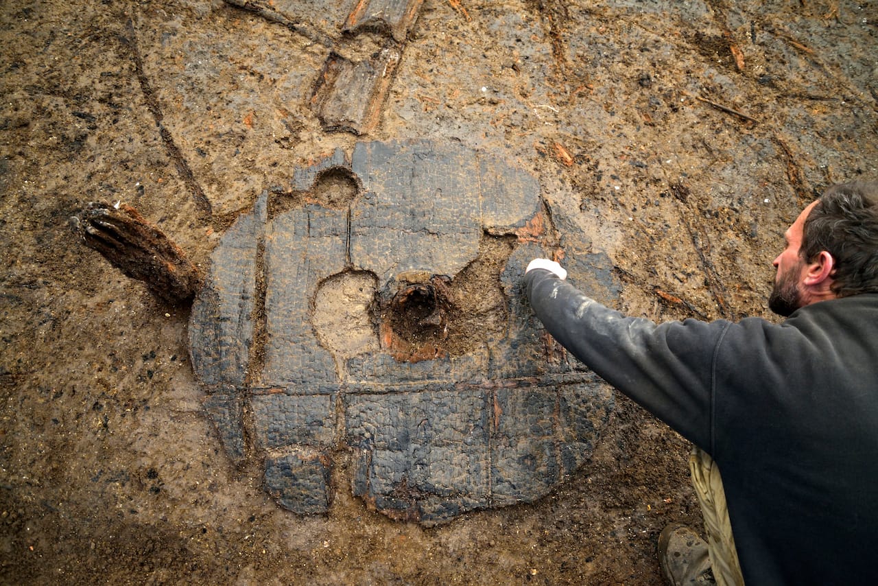 Bronze Age Wheel at Must Farm one metre in diameter, with hub clearly visible. Copyright Cambridge Archaeological Unit, photo by Dave Webb