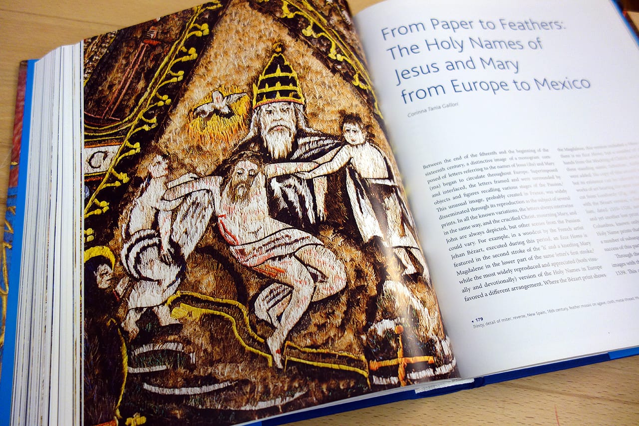Pages from 'Images Take Flight: Feather Art in Mexico and Europe' (photo of the book for Hyperallergic)