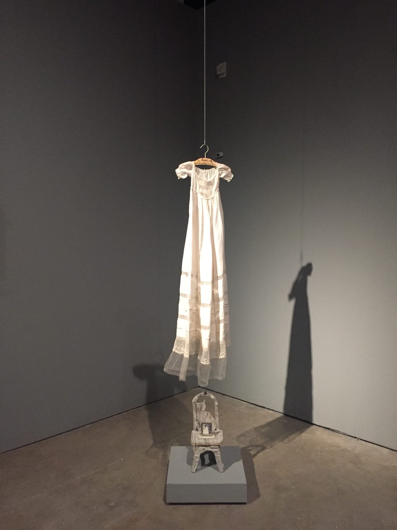 Installation view, Betye Saar, "A Loss of Innocence" (1998), installation: chair, dress 50" x 12" x 12"