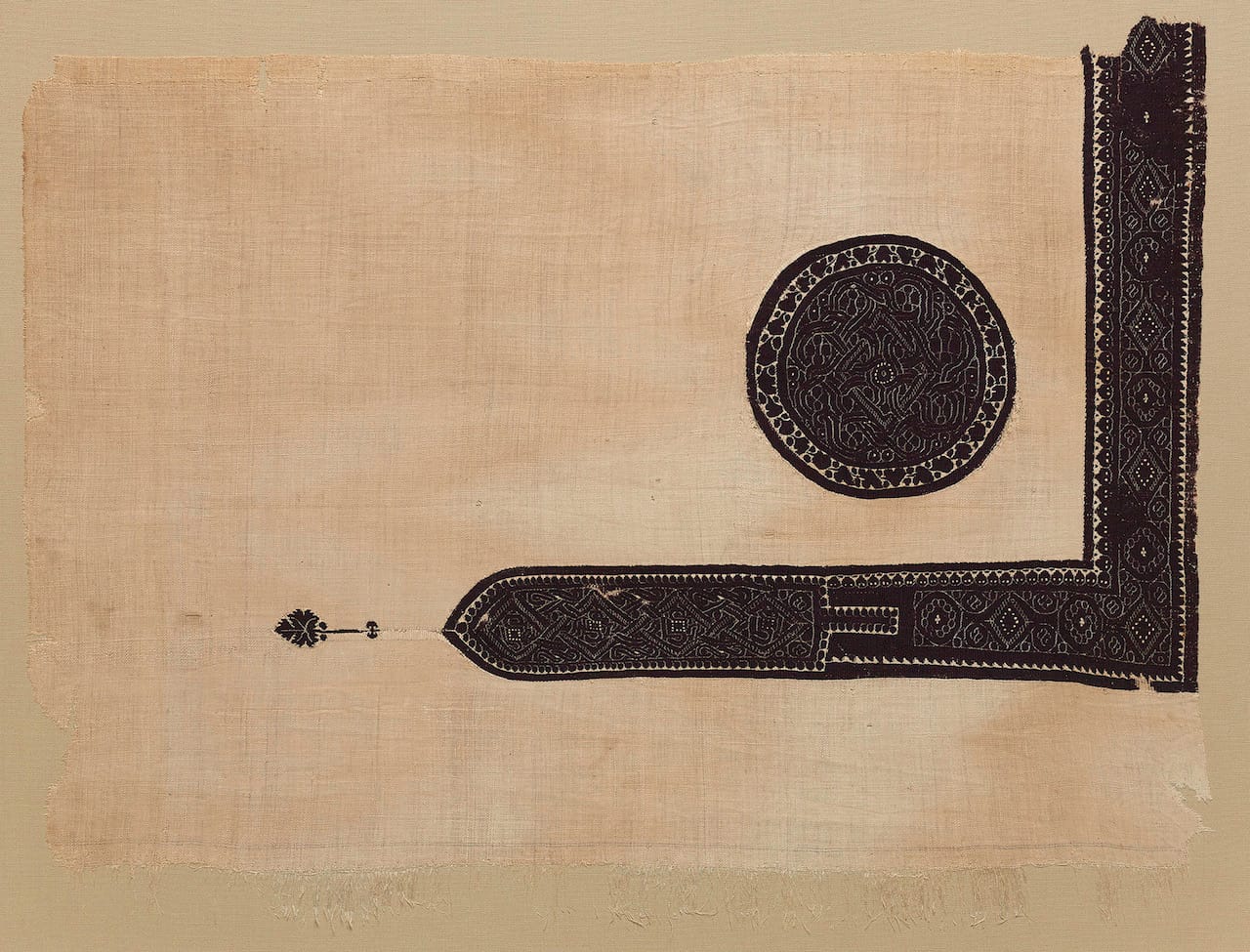 Fragment possibly of a furnishing with roundel and L-shaped band with interlace ornament, tapestry weave of dyed wool, plain (tabby) ground weave of undyed linen (Egypt, 3rd- 6th century CE) (© The Metropolitan Museum of Art, image courtesy Art Resource, NY)