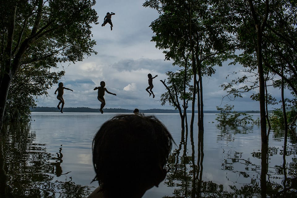 1. Tapajós River, Itaituba, Pará State, Brazil, on February 10, 2015. Indigenous children jump into the water as they play around the Tapajós river, in the Munduruku tribal area called Sawré Muybu.