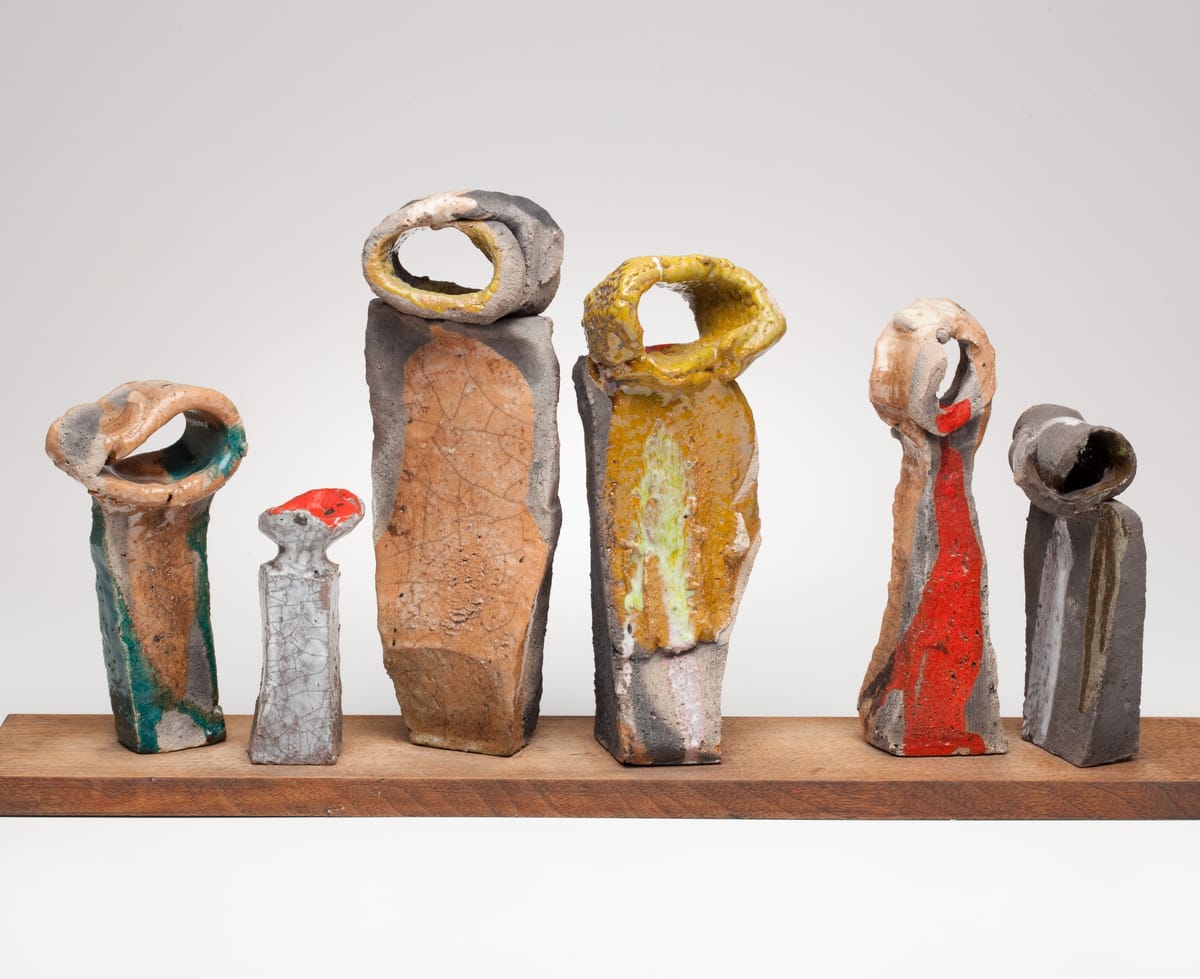 Betty Feves, "Six Figures" (date unknown), Raku on wooden base, Collection of Feves Family, Museum of Contemporary Craft (photo by Dan Kvitka)