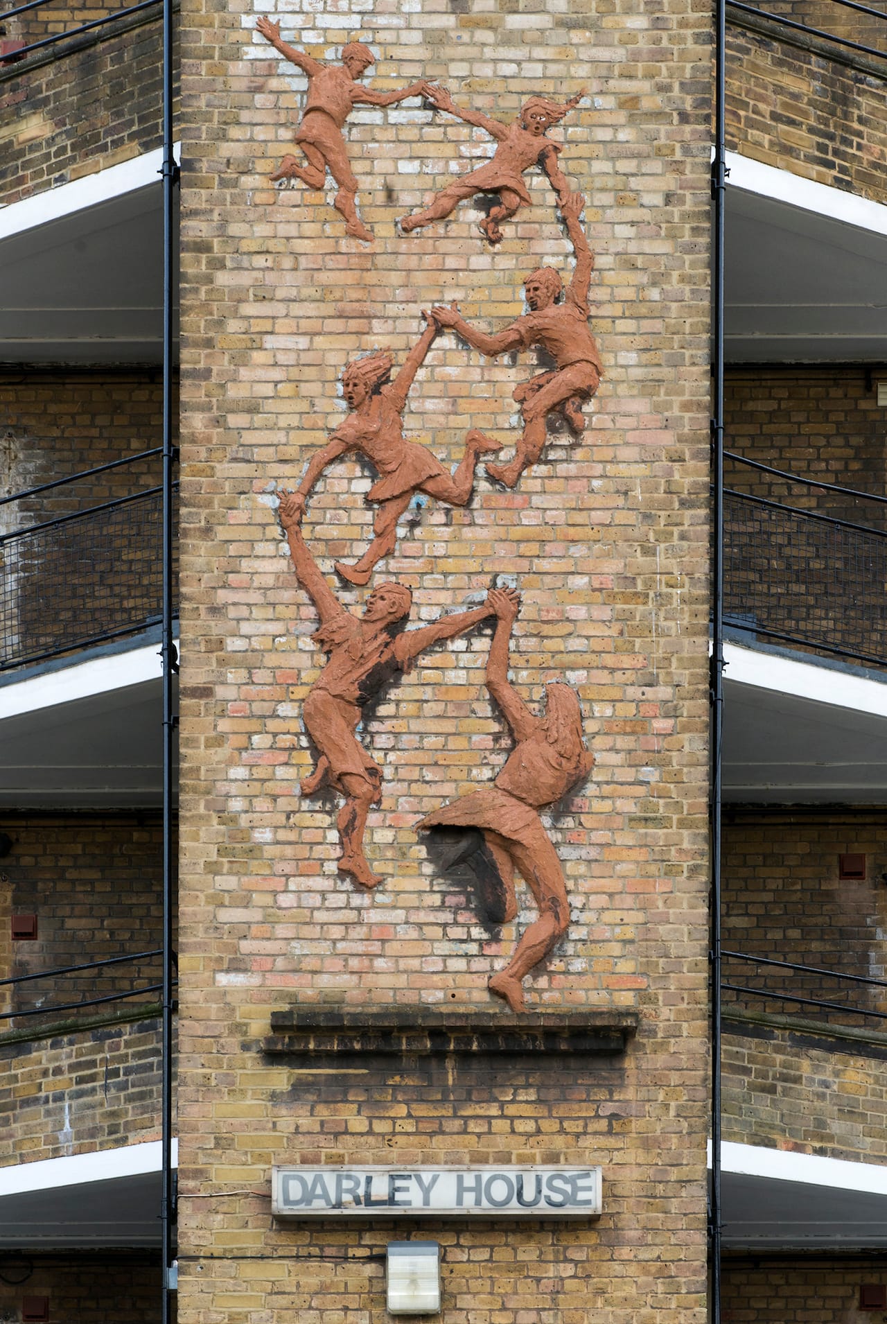 Public sculpture 'Children Playingl' by Peter Laszio Peri. Artwork dated 1948 Darley House, Tyers Street, Vauxhall Gardens Estate, Lambeth, London Relief sculpture on staircase tower
