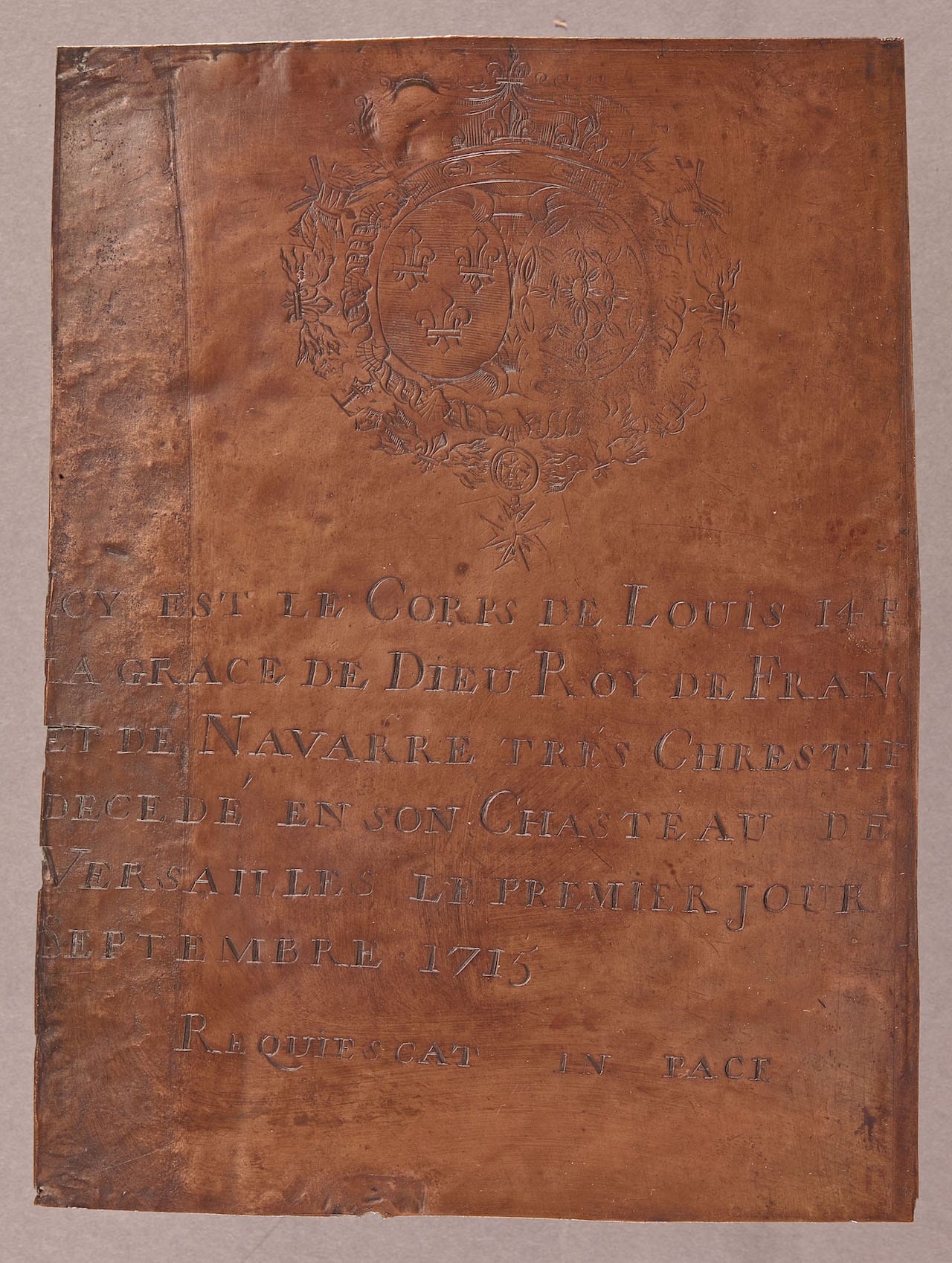 Copper funerary inscription (1715) torn off Louis XIV's coffin in 1793. The inscription reads: "Here lies the body of Louis XIV by the grace of god, very Christian King of France and of Navarre — deceased in his Palace of Versailles on the 1st of September 1715. Rest in Peace." (Paris, musée de Cluny, musée national du Moyen Âge, en dépôt à la basilique-cathédrale Saint-Denis de Saint-Denis © DR)