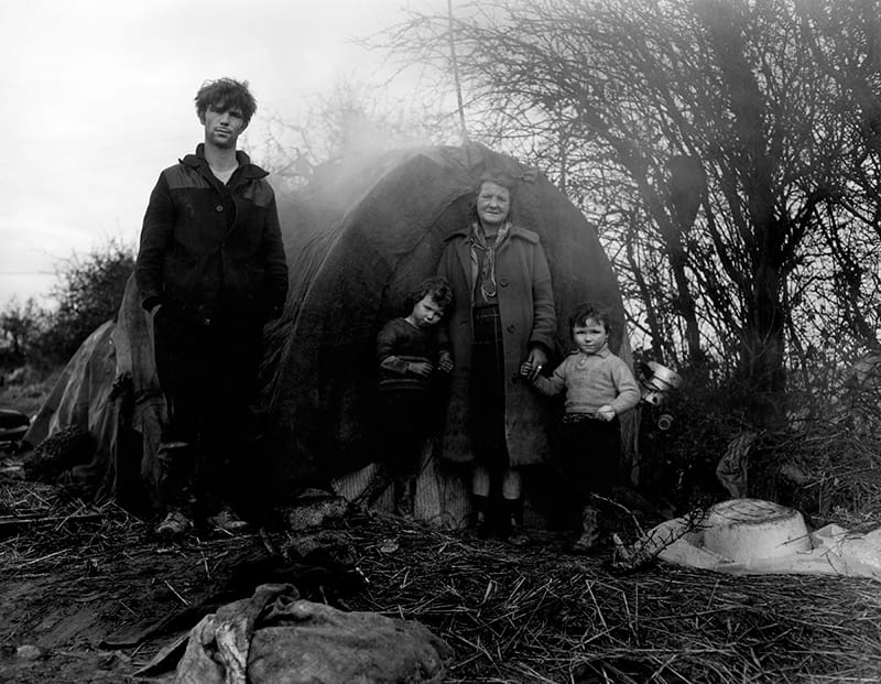 Wendy Snyder MacNeil, "Untitled [Young man, old woman and two children standing outside a tent]" (1968–69), from the series 'Irish Tinkers,' gelatin silver print, Wendy Snyder MacNeil Archive, Ryerson Image Centre