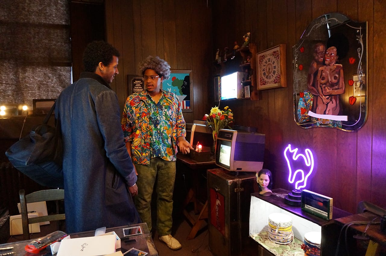 Azikiwe Mohammed (right) talking to a visitor in his installation "Jimmy's Thrift," curated by Dustin Yellin