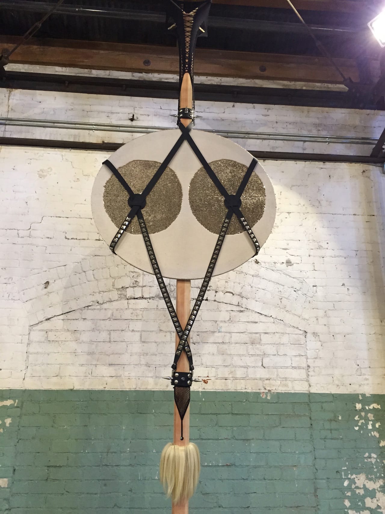 Laura Schnitgner, "V-plunge" (2016), Leather, wood, wig, nylon, sequin fabric, studs, spikes, 180 x 20 x 48 in.