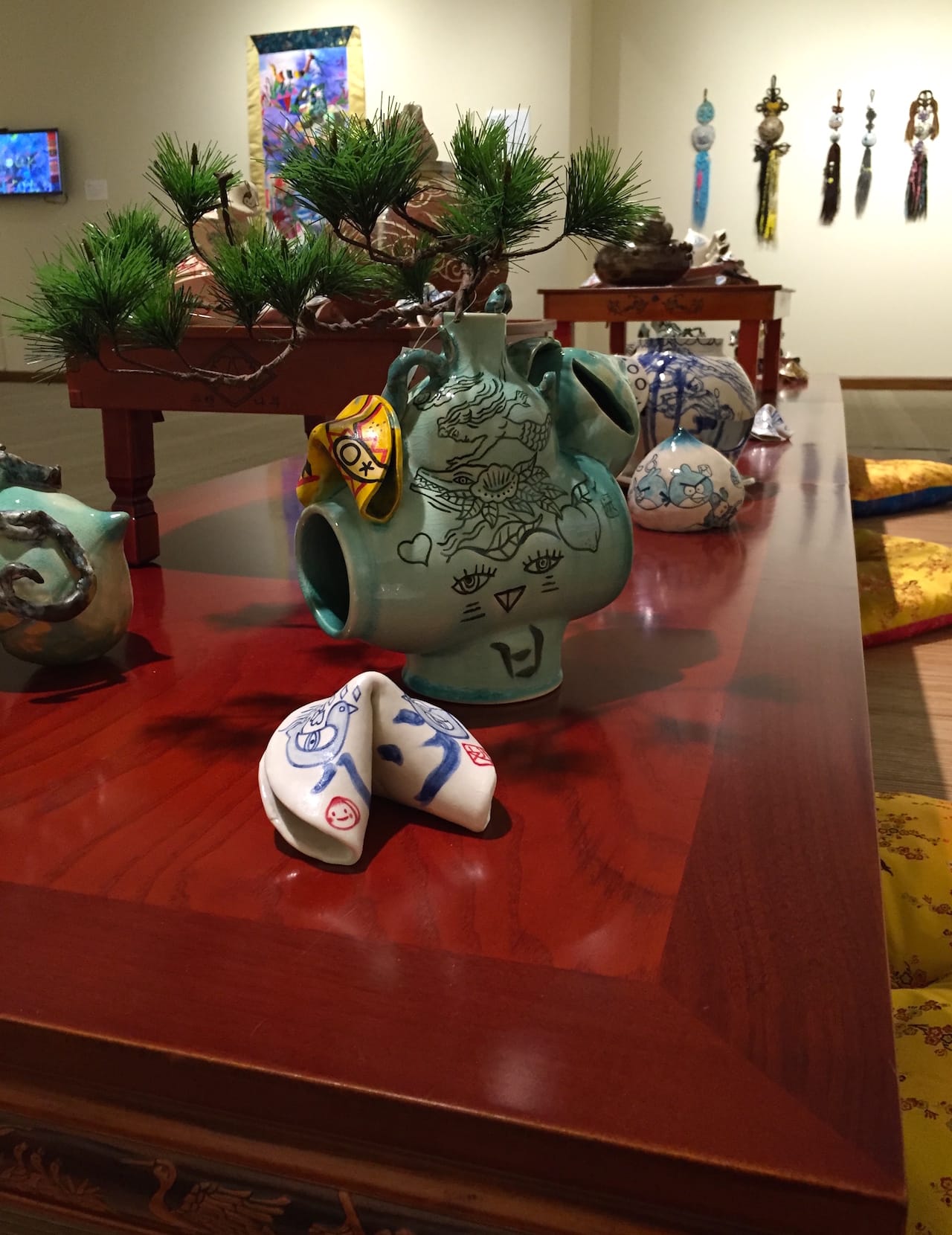 Display of ceramic works in 'Jiha Moon: Double Welcome, Most Everyone's Mad Here' at the Kalamazoo Institute of Arts