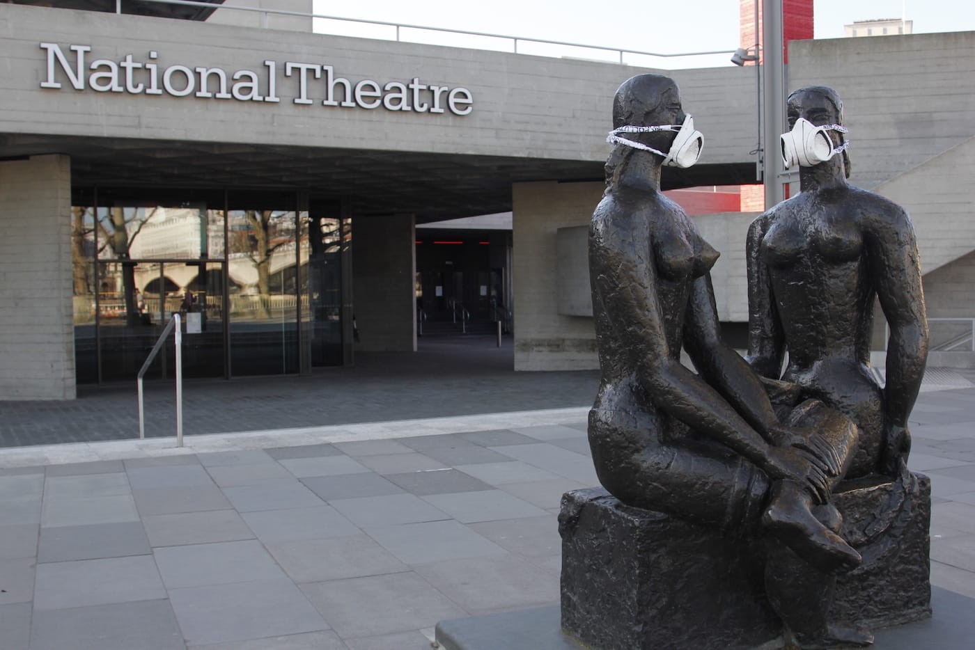 Greenpeace activists fit the London Pride statue, outside The National Theatre, with an emergency face mask
