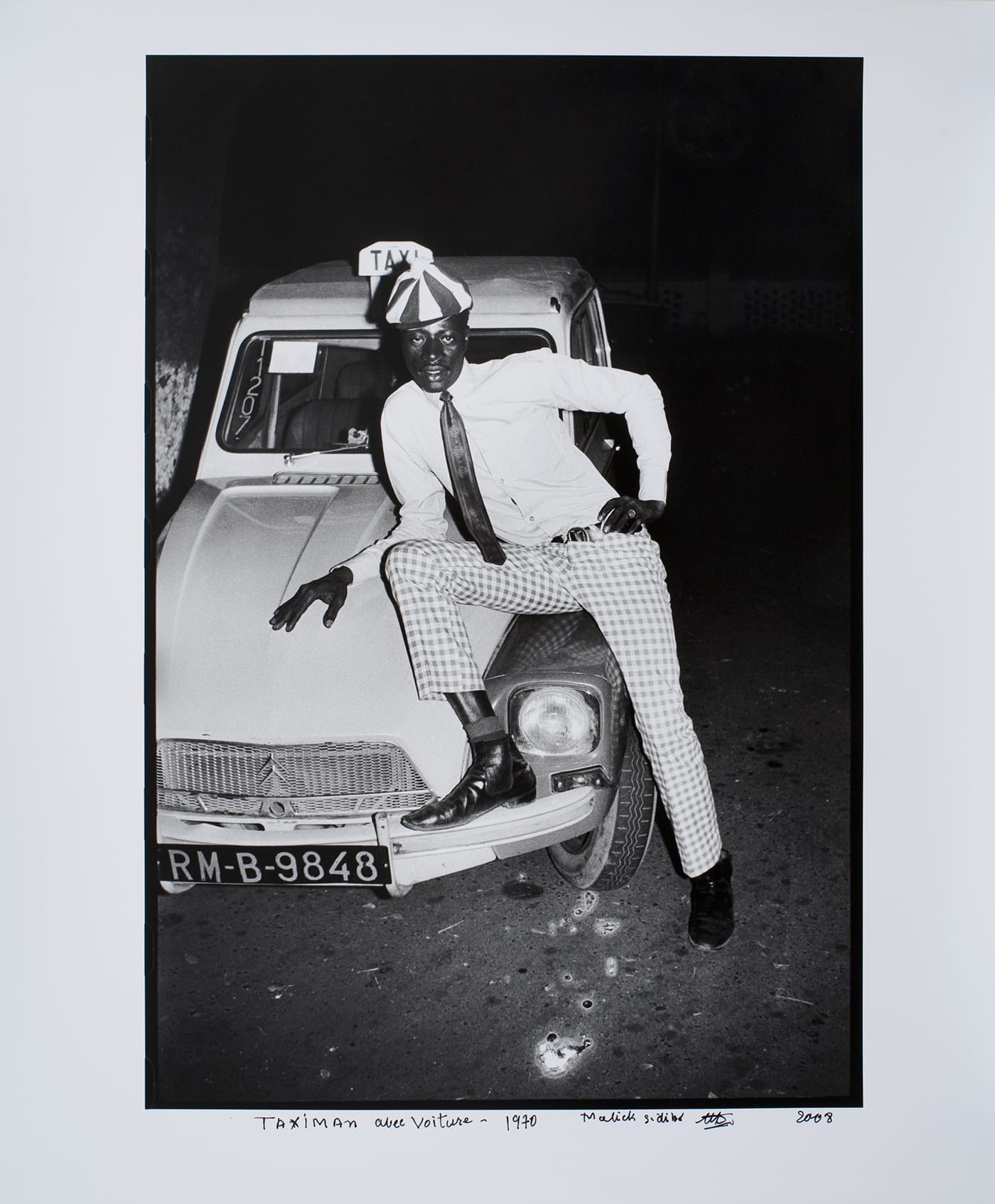 Malick Sidibé, "Taximan avec Voiture" (1970/2008), gelatin silver print, 20 7/8 x 14 1/8 in image size, 30 1/2 x 23 7/8 x 1 1/2 in framed (©Malick Sidibé, courtesy the artist and Jack Shainman Gallery, New York) 