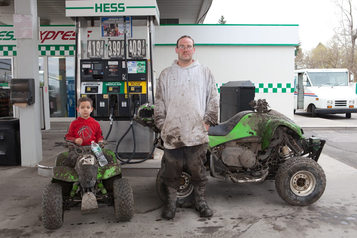 USA. Rochester, New York. 2012. Bryan and Bryan Jr. Short. Hess Gas Station, Jeferson Road.