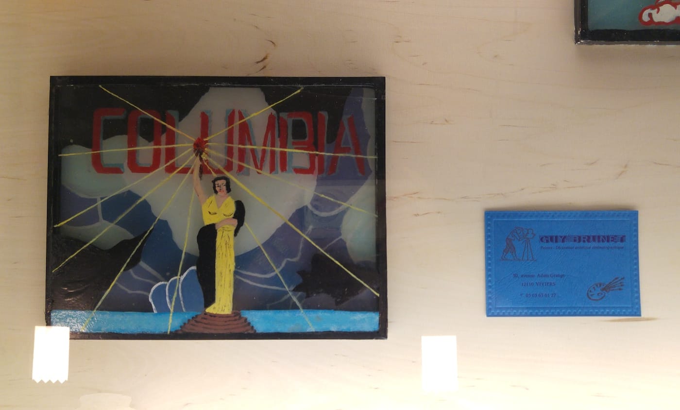 One of Guy Brunet's hand-painted film company title images and a business card