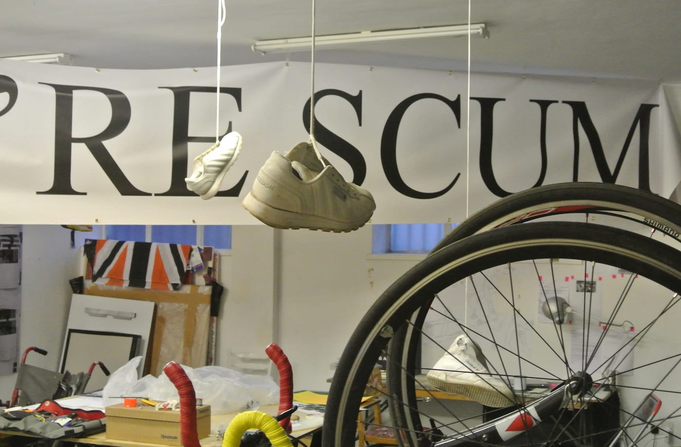 A hanging banner and suspended Reebok sneakers in Dominic from Luton's studio