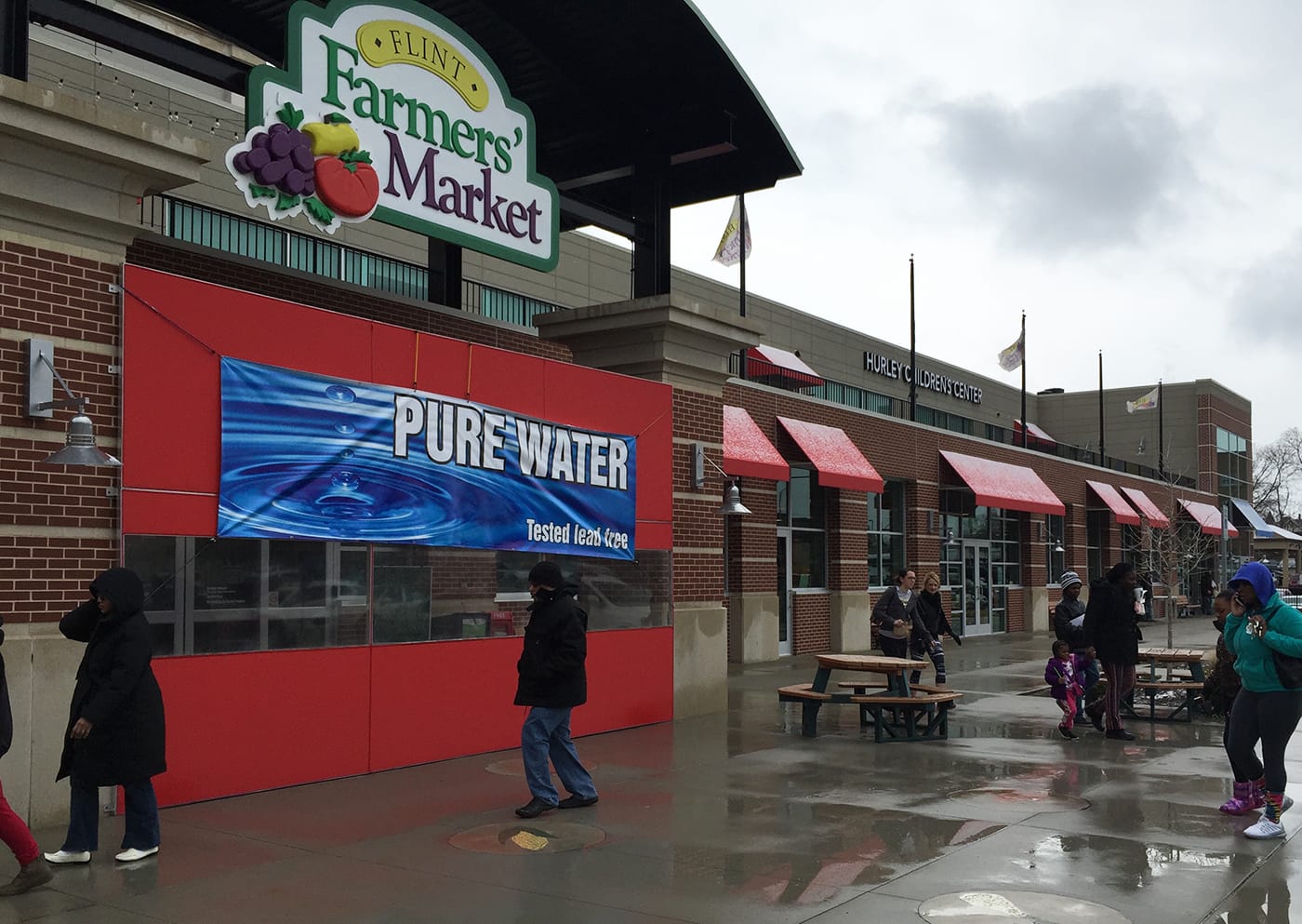 A banner on the Flint Farmers’ Market, located some three blocks east of Saginaw Street, assures visitors and clientele that the water inside has been tested and is safe.