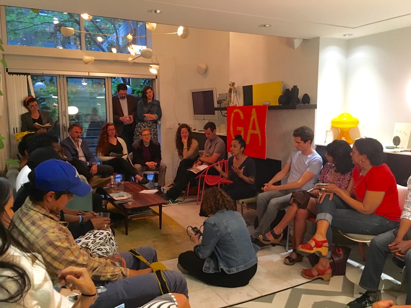 Gentrifiers Anonymous Meeting Saturday, May 14, in Chelsea. One of the organizers, Oasa DuVernay is in the center, beneath the GA flag. Photos courtesy of Jeff Kasper of More Art