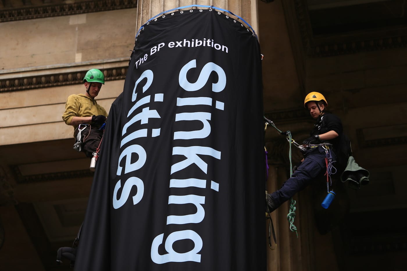 Greenpeace activists climb the British Museum in protest at BP’s sponsorship of a new exhibition ‘Sunken Cities’. The climbers unfurl seven huge banners down the front columns of the British Museum. The banners carry the names of cities and regions struck by flooding and climate change disasters.