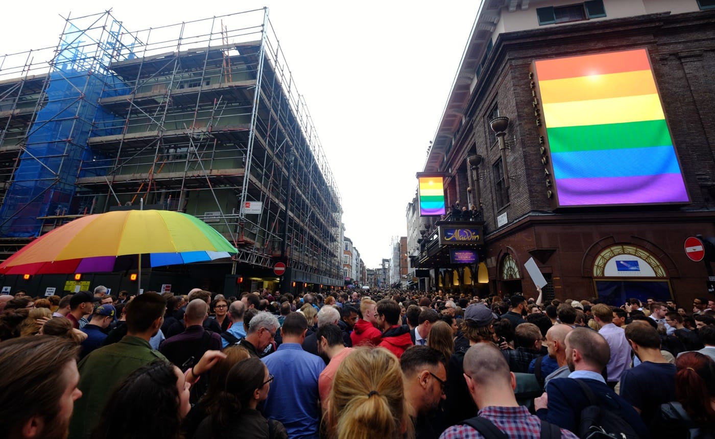 London's vigil in memory of the victims of Orlando's gay nightclub terror attack. Many hundreds of people, some wearing rainbow flags and others carrying placards, came to Old Compton Street in London's Soho district to show solidarity with the victims