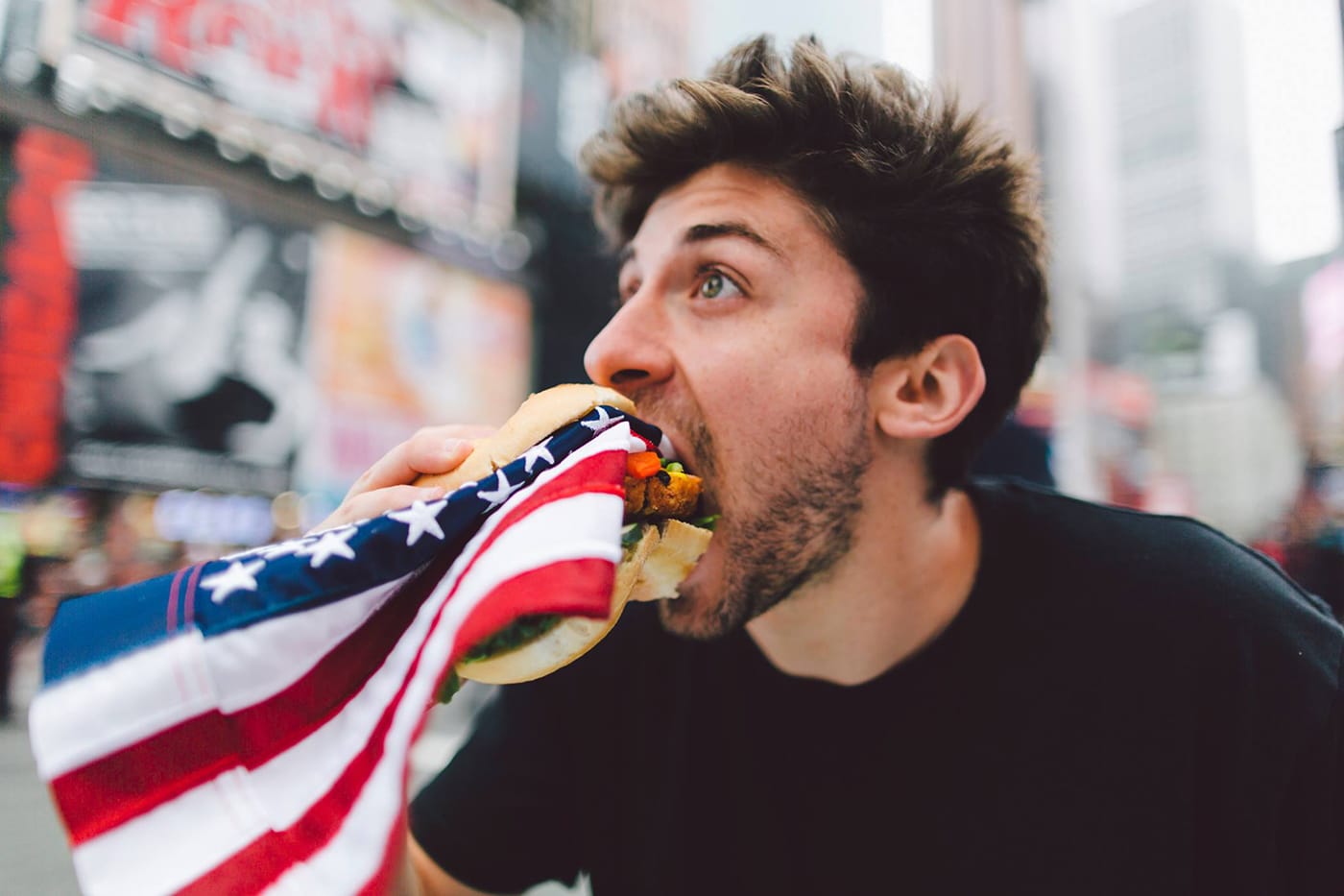 Artist eats American flag (image via Facebook)