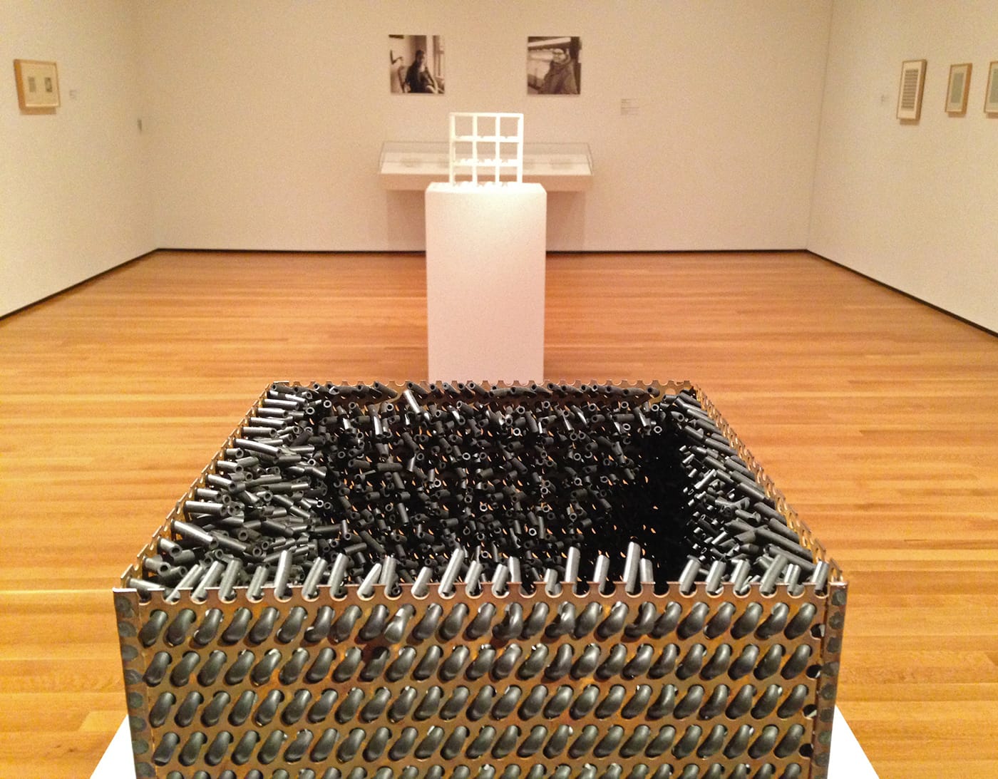 Foreground: Eva Hesse, "Accession V" (1968), galvanized steel and rubber; background: Sol LeWitt, "3 x 3 x 3" (1965), painted wood