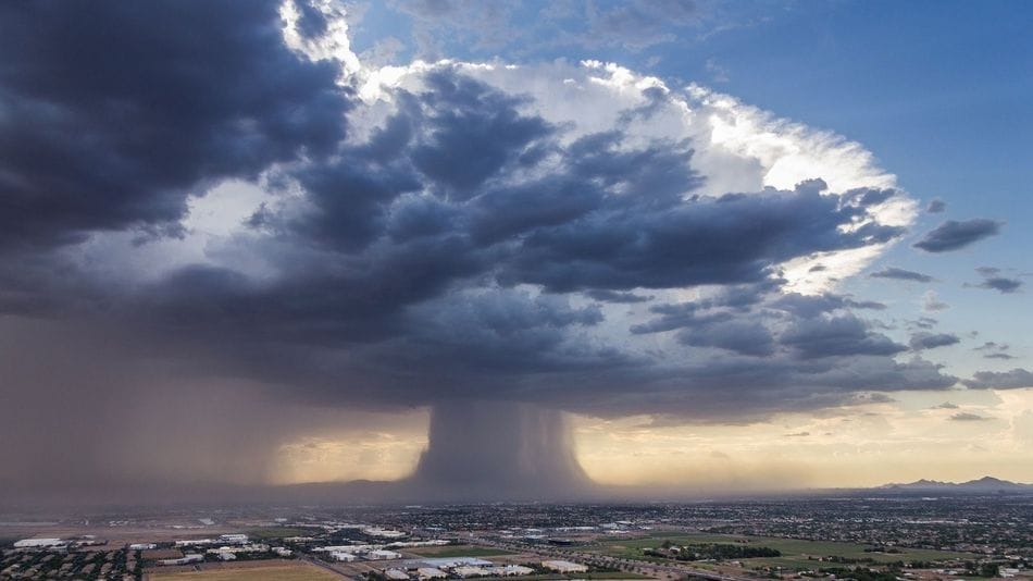 While helicopter pilot Andrew Park was flying over Phoenix this week, photographer Jerry Ferguson captured what appears to be a giant foreboding mushroom cloud hanging over the city. In actuality the scene is a weather cluster called a “microburst,” a phenomenon that occurs when cooled air from a thunderstorm rushes to the ground and spreads over the land at speeds over 100 miles per hour causing a powerful and centralized air current. (via Colossal) 