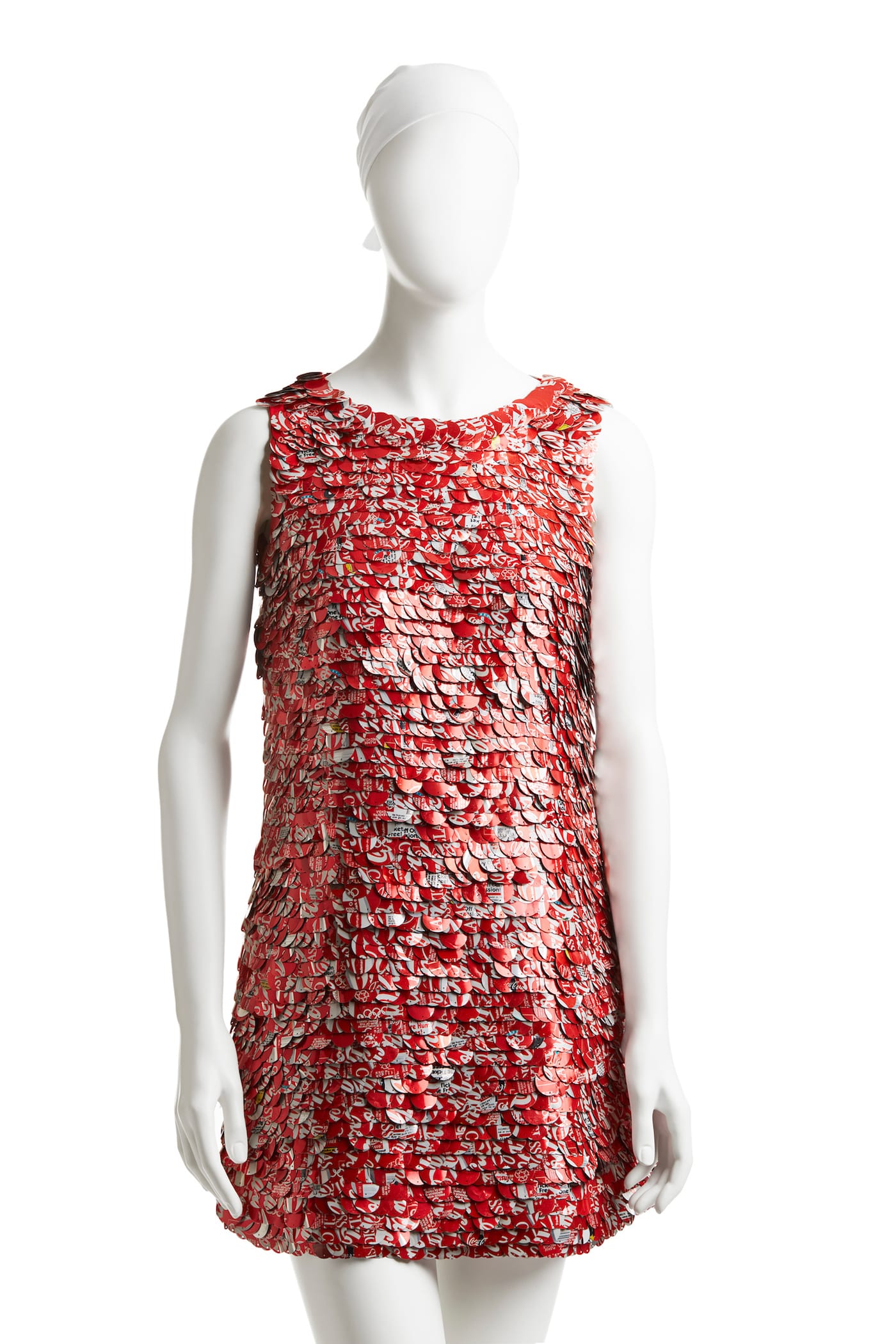 The Real Thing, Coca-Colañcan paillette dress, spring 1994. The Coke can makes an improbable appearance on the runway: Mizrahi used an elaborate process to create these custom paillettes from real Coca-Cola cans. He worked with the charity We Can, which employed homeless New Yorkers to collect cans to recycle; these were shipped to the sequin-maker Langlois-Martin in Paris, where they were cut into paillettes that were then sent to India to be beaded onto dresses. The result is a high-fashion, nearly weightless modern take on a ubiquitous American icon.