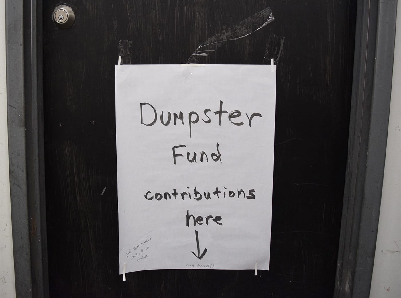 A sign directing tenants of 112 2nd Avenue to pitch in for a dumpster