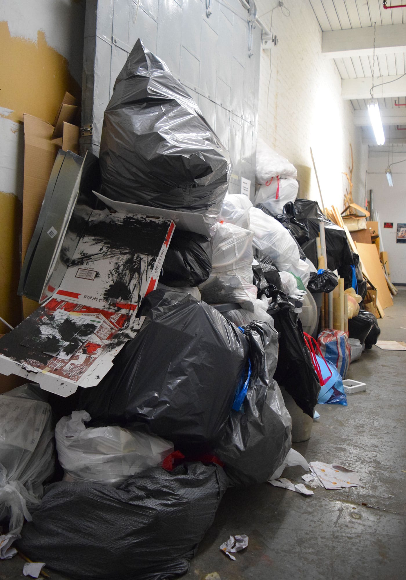 Trash fills a hallway at 112 2nd Avenue in Gowanus