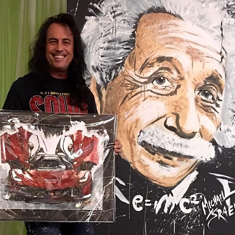 Michael Israel and his paintings (photo via @michaelisraelart/Instagram) (click to enlarge)
