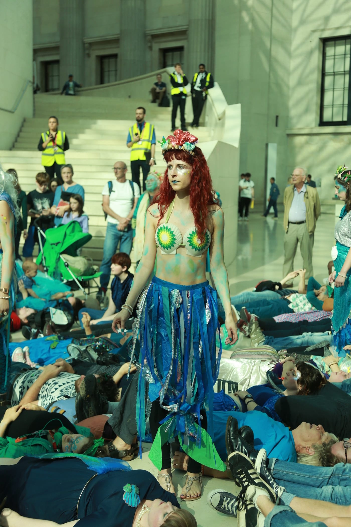 Merfolk walk through the "splashmob" during Sunday's performance protest at the British Museum