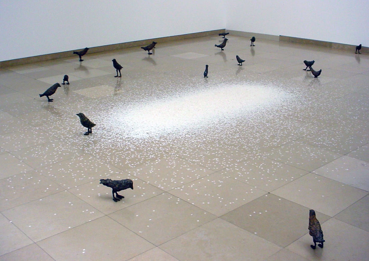 Ugo Rondinone, “Primitive” (2011–12), installation of 59 bronze birds, collection Maja Hoffmann/Fondation LUMA, and “Thank you Silence” (2005), wood, paper, metal grill, motor, courtesy of the artist (photo by the author for Hyperallergic)