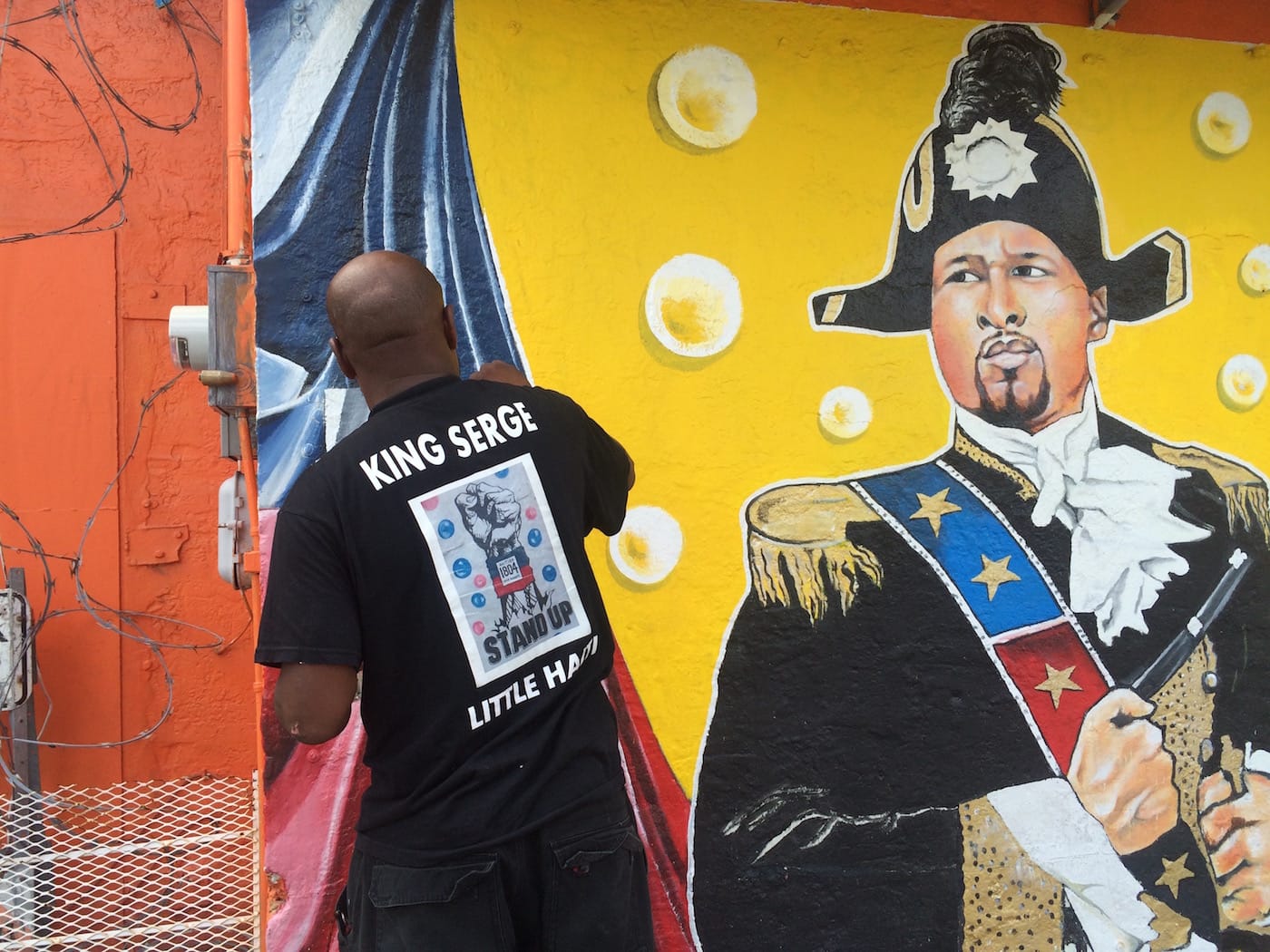 Serge Toussaint working on a mural in Little Haiti (all photos by the author for Hyperallergic)