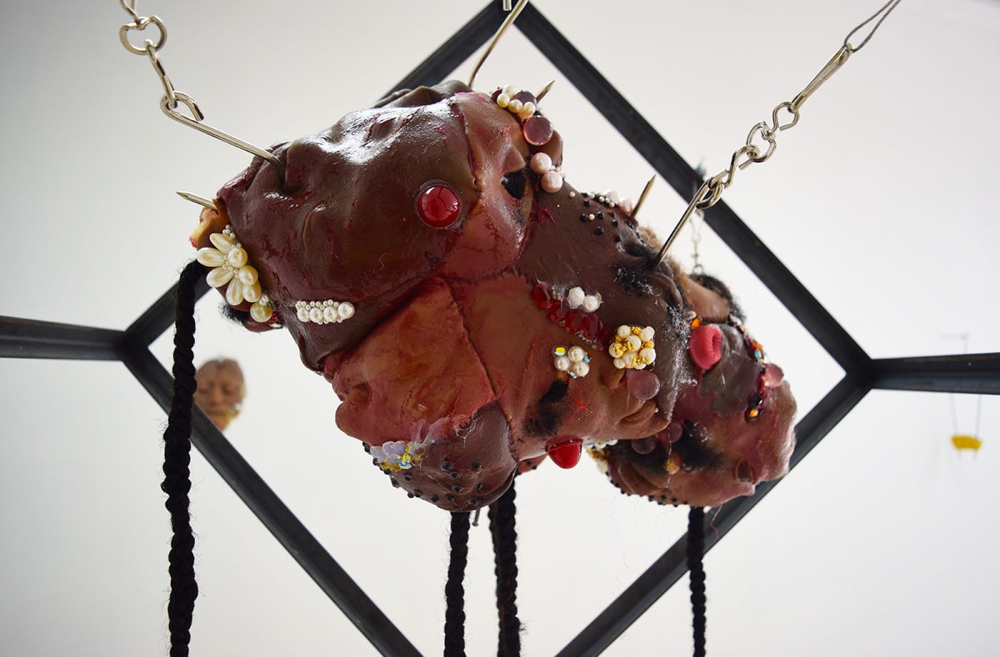 Doreen Garner, "Suspension" (2016, detail), silicone, pearls, hair weave, speculum, steel cage, steel chain, suspension hooks, 24 x 24 x 24 in; 36-in steel chain
