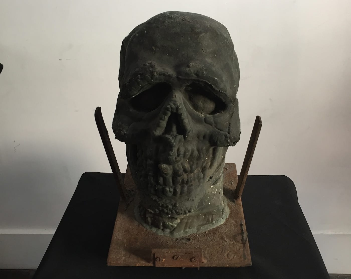 Old, metal mask mold in The Art of the Halloween Mask at Lethal Amounts.