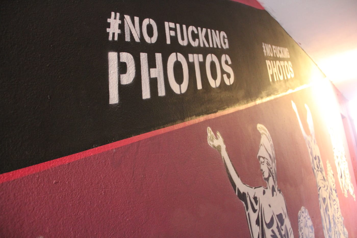 Partial view of Trompettersteeg with No Fucking Photos murals