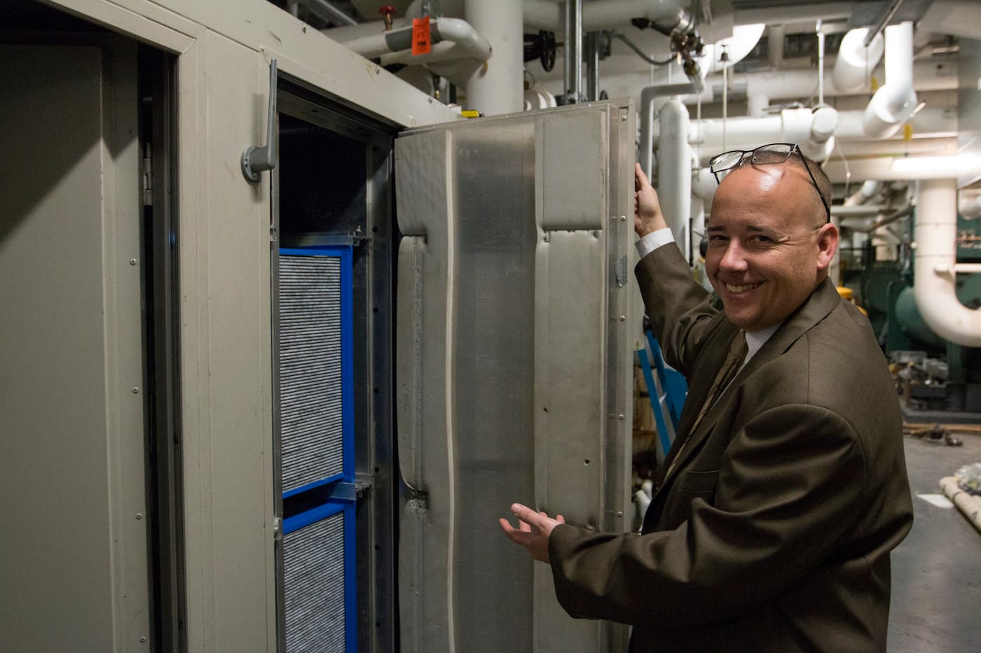 Nelson Nieves from Building Operations presents the air filtration system under the lobby floor (photo by Manuel Martagon, © 2016 The Museum of Modern Art)